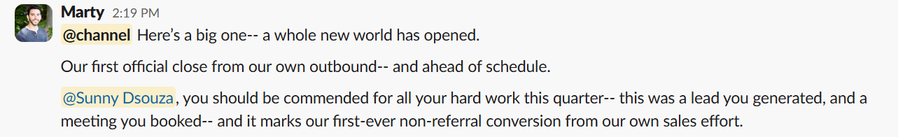 Slack message from Marty announcing the company's first close from its own outbound, crediting Sunny for the lead and the booked meeting.